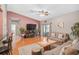 Open living room with wood floors, a cozy seating arrangement, and a flatscreen TV at 1789 Elm Dr, Venice, FL 34293