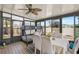 Bright sunroom featuring a bunk bed, dining table, fan, and plenty of windows at 1789 Elm Dr, Venice, FL 34293