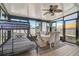 Bright sunroom featuring a bunk bed, dining table, fan, and plenty of windows at 1789 Elm Dr, Venice, FL 34293