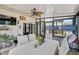 Bright sunroom featuring a bunk bed, dining table, fan, and plenty of windows at 1789 Elm Dr, Venice, FL 34293