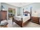Bedroom featuring a four-poster bed, ceiling fan, and sliding glass doors leading to a patio at 1886 Vamo Dr, Sarasota, FL 34231