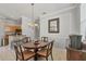 Dining area featuring a round wood table with four chairs and view of a kitchen area at 1886 Vamo Dr, Sarasota, FL 34231
