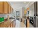 Spacious kitchen featuring granite countertops, stainless appliances, and sliding glass doors to outdoor patio at 1886 Vamo Dr, Sarasota, FL 34231