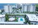 Aerial view showing a swimming pool and the adjacent beachfront condos at 2100 Benjamin Franklin Dr # 201, Sarasota, FL 34236