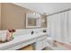 A neutral bathroom featuring a shower, sink and vanity, and ample lighting at 2100 Benjamin Franklin Dr # 201, Sarasota, FL 34236