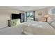 Bedroom featuring a sliding glass door to a balcony and neutral decor at 2100 Benjamin Franklin Dr # 201, Sarasota, FL 34236