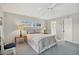 Bright bedroom featuring a ceiling fan, natural light, and calming decor at 2100 Benjamin Franklin Dr # 201, Sarasota, FL 34236