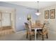 Cozy dining room with pendant light fixture; kitchen visible through pass-through at 2100 Benjamin Franklin Dr # 201, Sarasota, FL 34236