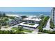 Beautiful exterior view of the condominium buildings with covered parking and manicured landscaping near the beach at 2100 Benjamin Franklin Dr # 201, Sarasota, FL 34236