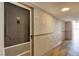 Hallway with apartment doors, neutral wall color, wood-look floors, and recessed lighting at 2100 Benjamin Franklin Dr # 201, Sarasota, FL 34236