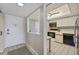 Bright kitchen featuring a ceiling fan and appliances including a black oven, microwave, and dishwasher at 2100 Benjamin Franklin Dr # 201, Sarasota, FL 34236