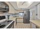 Bright kitchen with stainless steel refrigerator, plenty of counter space, and modern appliances at 2100 Benjamin Franklin Dr # 201, Sarasota, FL 34236