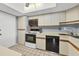 Kitchen with appliances and white cabinets; updated space with eat-in features and good lighting at 2100 Benjamin Franklin Dr # 201, Sarasota, FL 34236