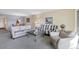 Inviting living room with neutral décor, including a glass coffee table, modern furniture, and an art piece at 2100 Benjamin Franklin Dr # 201, Sarasota, FL 34236
