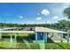 A scenic patio view overlooking a parking lot and lush, tropical landscaping at 2100 Benjamin Franklin Dr # 201, Sarasota, FL 34236