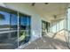 Spacious patio with seamless glass doors and ceiling fan, offering beautiful scenic views and natural light at 2100 Benjamin Franklin Dr # 201, Sarasota, FL 34236
