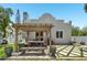 Relaxing backyard patio features a pergola, outdoor dining, and custom stone tile, perfect for entertaining or enjoying the outdoors at 2221 Bahia Vista St, Sarasota, FL 34239
