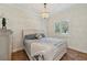 Serene bedroom with a decorative chandelier, stylish bed, and a sunlit window at 2221 Bahia Vista St, Sarasota, FL 34239