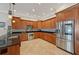 Stylish kitchen with stainless steel appliances and warm wood cabinets at 2221 Bahia Vista St, Sarasota, FL 34239