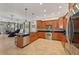 Open kitchen with stainless steel appliances and cherry wood cabinetry at 2221 Bahia Vista St, Sarasota, FL 34239