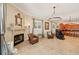 Elegant living room featuring a fireplace, leather chairs, and an open view to the kitchen at 2221 Bahia Vista St, Sarasota, FL 34239