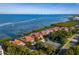 Breathtaking waterfront view of townhomes, showcasing a tennis court and beautiful waterfront scenery at 2282 Harbour Court Dr, Longboat Key, FL 34228