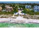 Breathtaking aerial view of the beach featuring beach pavilions, turquoise waters, and upscale properties at 2282 Harbour Court Dr, Longboat Key, FL 34228