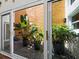 Open sliding glass doors reveal an atrium with lush plants and rock ground covering at 2282 Harbour Court Dr, Longboat Key, FL 34228