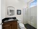 Modern bathroom featuring a sleek vanity, frameless shower, neutral paint, and updated fixtures at 2282 Harbour Court Dr, Longboat Key, FL 34228