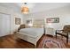 Cozy bedroom featuring wood floors, king bed with nightstands, and stylish decor at 2282 Harbour Court Dr, Longboat Key, FL 34228