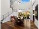 Bright dining room with hardwood floors, modern light fixture, and staircase at 2282 Harbour Court Dr, Longboat Key, FL 34228