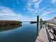 Wooden dock on the water with a serene view of the calm bay under a clear sky at 2282 Harbour Court Dr, Longboat Key, FL 34228