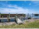 Wooden dock for lake access, with beautiful natural landscape and clear skies at 2282 Harbour Court Dr, Longboat Key, FL 34228