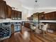 Gourmet kitchen featuring dark wood cabinetry, a wine fridge, and island seating at 2282 Harbour Court Dr, Longboat Key, FL 34228