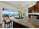 Bright kitchen with large island, dark wood cabinets and scenic backyard views at 2282 Harbour Court Dr, Longboat Key, FL 34228