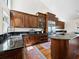 Well-appointed kitchen featuring dark wood cabinets, a large stainless steel refrigerator and granite countertops at 2282 Harbour Court Dr, Longboat Key, FL 34228