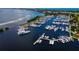 Aerial view of a marina, showcasing numerous boats, docks, and waterfront activities, ideal for boating enthusiasts at 2282 Harbour Court Dr, Longboat Key, FL 34228