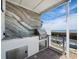 Outdoor kitchen with stainless steel BBQ, sink, stone backsplash and waterfront view at 2282 Harbour Court Dr, Longboat Key, FL 34228