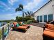 Outdoor patio with lounge chairs overlooking lush landscaping and a waterfront view at 2282 Harbour Court Dr, Longboat Key, FL 34228