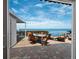 Waterfront patio offers an outdoor dining area with beautiful water views and string lights at 2282 Harbour Court Dr, Longboat Key, FL 34228
