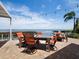 Outdoor patio with dining table, lounge area, and waterfront view perfect for entertaining at 2282 Harbour Court Dr, Longboat Key, FL 34228