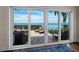 The bright sunroom features full windows showing an outdoor patio with furniture and a beautiful ocean view at 2282 Harbour Court Dr, Longboat Key, FL 34228