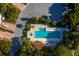 Aerial view of the pool and spa area surrounded by beautiful landscaping and nearby parking spots at 2282 Harbour Court Dr, Longboat Key, FL 34228