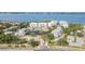Breathtaking aerial view of a luxury residential complex with a pool, tennis courts, and bay access at 242 Hidden Bay Dr # 603, Osprey, FL 34229