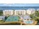 Community aerial view shows tennis courts, clubhouse, hot tub, pool, and waterway access at 242 Hidden Bay Dr # 603, Osprey, FL 34229