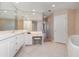 Bright bathroom with soaking tub, tile floors, and plenty of counter space at 242 Hidden Bay Dr # 603, Osprey, FL 34229