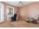 Bedroom features a desk area, comfortable chair, and natural light from a window and glass door at 242 Hidden Bay Dr # 603, Osprey, FL 34229