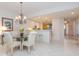 Open dining area showcasing tile flooring, decorative lighting, and a view into the kitchen at 242 Hidden Bay Dr # 603, Osprey, FL 34229