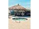 Hot tub area with shaded seating area covered with a tiki hut for relaxing in the warm weather at 242 Hidden Bay Dr # 603, Osprey, FL 34229