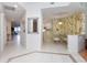 Inviting interior view showcasing white tile floors and a seamless flow to kitchen and living spaces at 242 Hidden Bay Dr # 603, Osprey, FL 34229